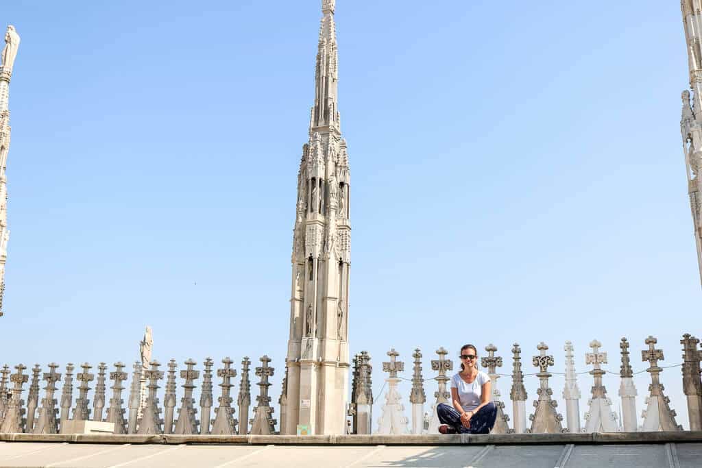 Frau sitzt auf Dach des Doms, dahinter Verzierungen